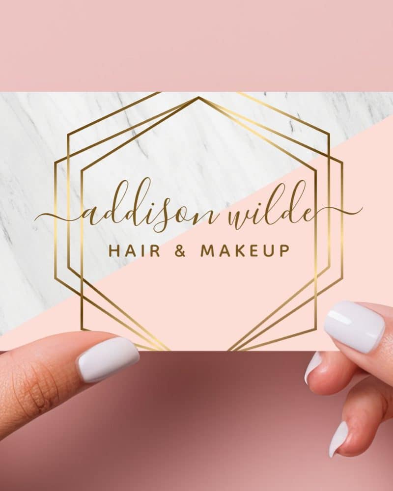 Pink and white marble business card with gold geometric frame, showcasing Addison Wilde Hair & Makeup.
