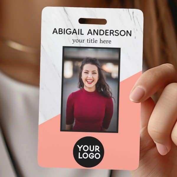 A Woman'S Id Card With A Marble And Peach Design, Featuring Her Photo And Name, Abigail Anderson.