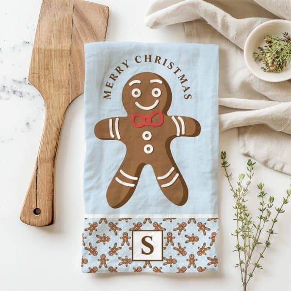 Christmas Tea Towel Featuring A Large Gingerbread Man With A Red Bow Tie.