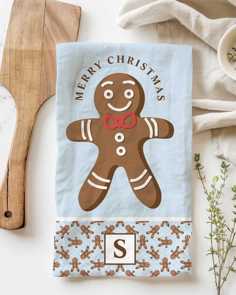 Christmas tea towel featuring a large gingerbread man with a red bow tie.