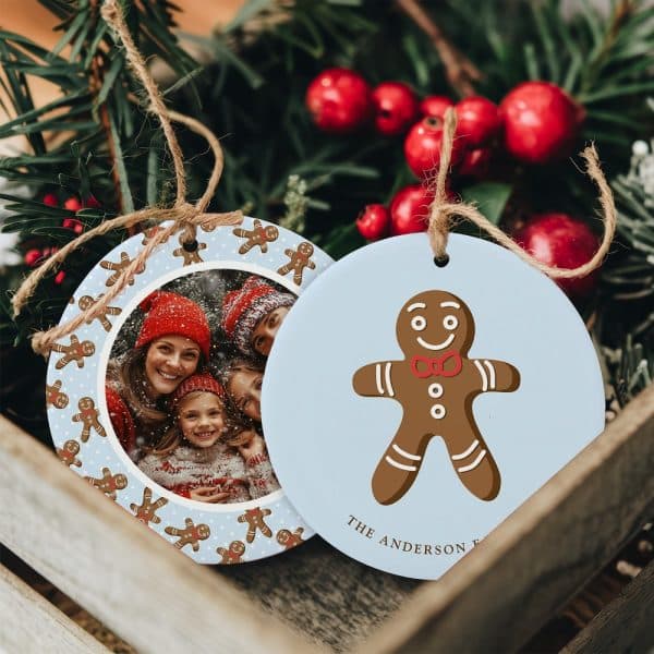 Two Round Christmas Ornaments. One Features A Family Photo Surrounded By Gingerbread Men. The Other Shows A Single Gingerbread Man And The Name Anderson.