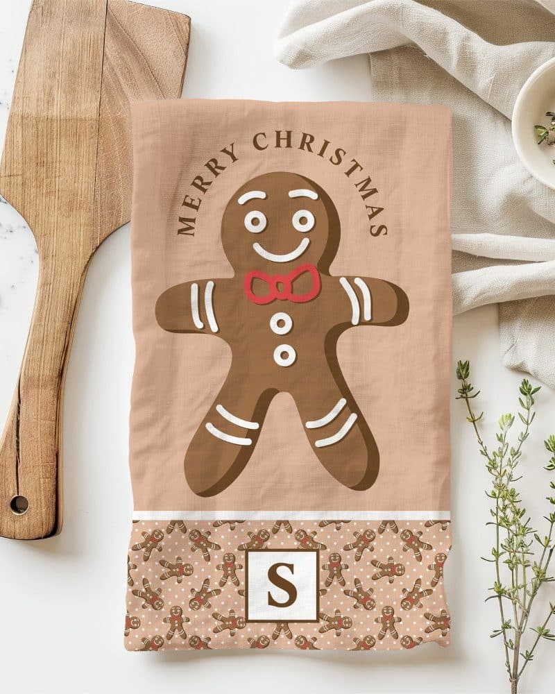 Kitchen towel featuring a large gingerbread man graphic and Merry Christmas text.
