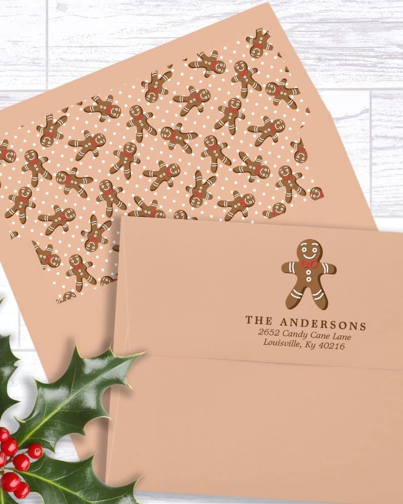 A peach-colored envelope with a gingerbread man design and return address.