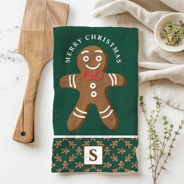 Green Christmas Tea Towel With A Large Gingerbread Man Illustration And Merry Christmas Text.