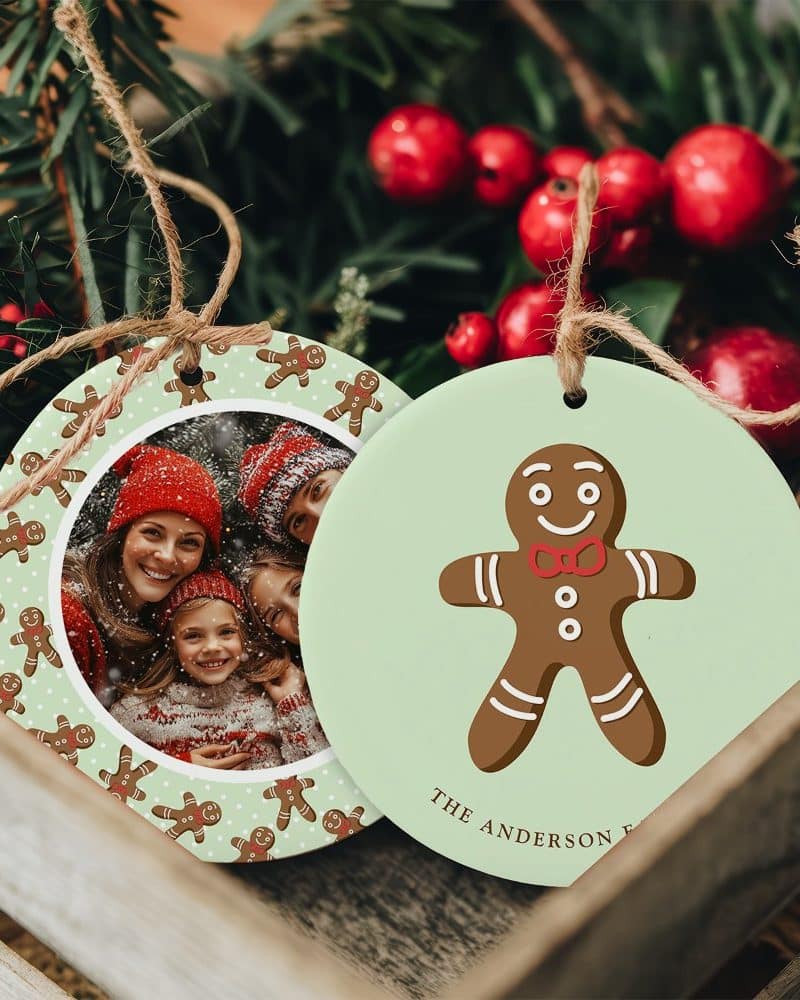 Two round Christmas ornaments. One features a family photo surrounded by gingerbread men. The other shows a gingerbread man.