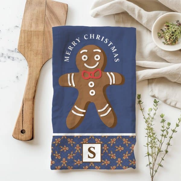 Christmas Tea Towel Featuring A Large Gingerbread Man And Merry Christmas Text.