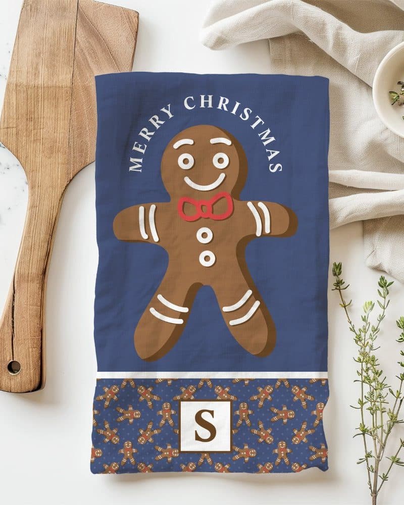Christmas tea towel featuring a large gingerbread man and Merry Christmas text.