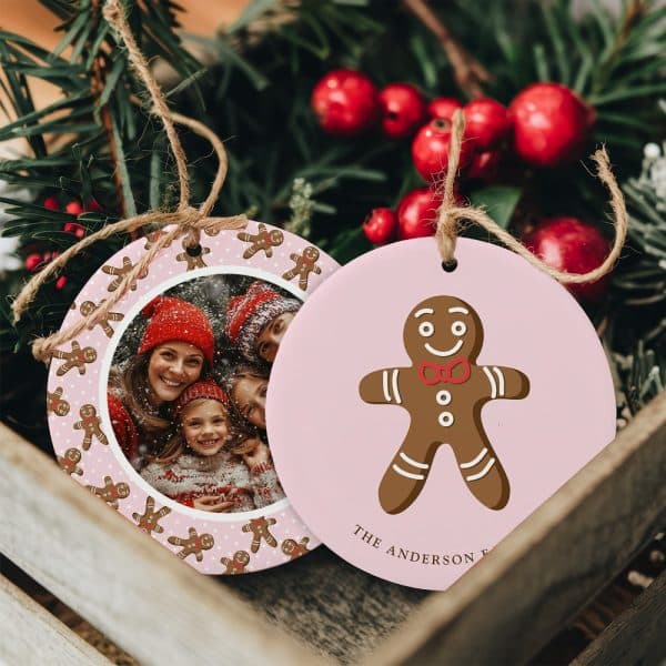 Two Pink Christmas Ornaments. One Features A Family Photo Surrounded By Gingerbread Men. The Other Shows A Single Gingerbread Man.