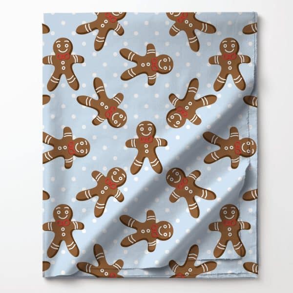 Light Blue Fabric With A Repeating Pattern Of Gingerbread Men And White Dots.