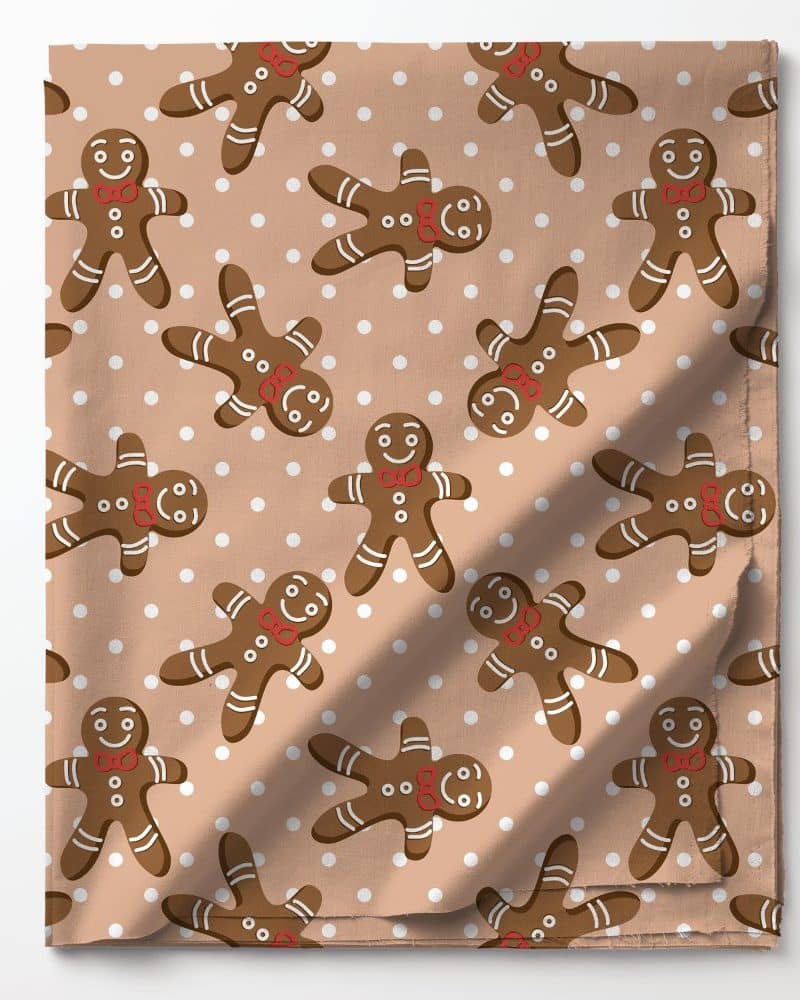 Tan fabric with a repeating pattern of gingerbread men and white dots.