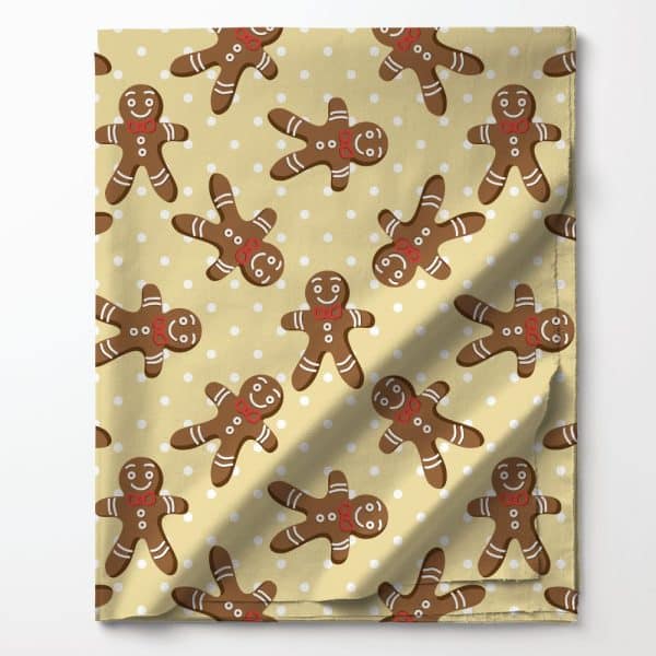 Beige Fabric With A Repeating Pattern Of Brown Gingerbread Men Wearing Red Bow Ties On A White Polka Dot Background.
