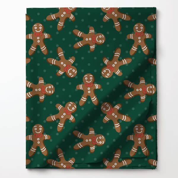 Green Fabric With A Repeating Pattern Of Smiling Gingerbread Men Wearing Red Bow Ties.