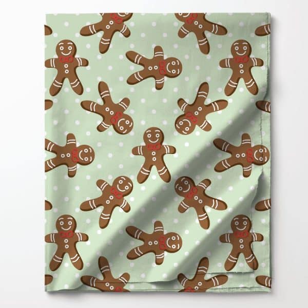 A Light Green Fabric With A Repeating Pattern Of Gingerbread Men Wearing Red Bow Ties.