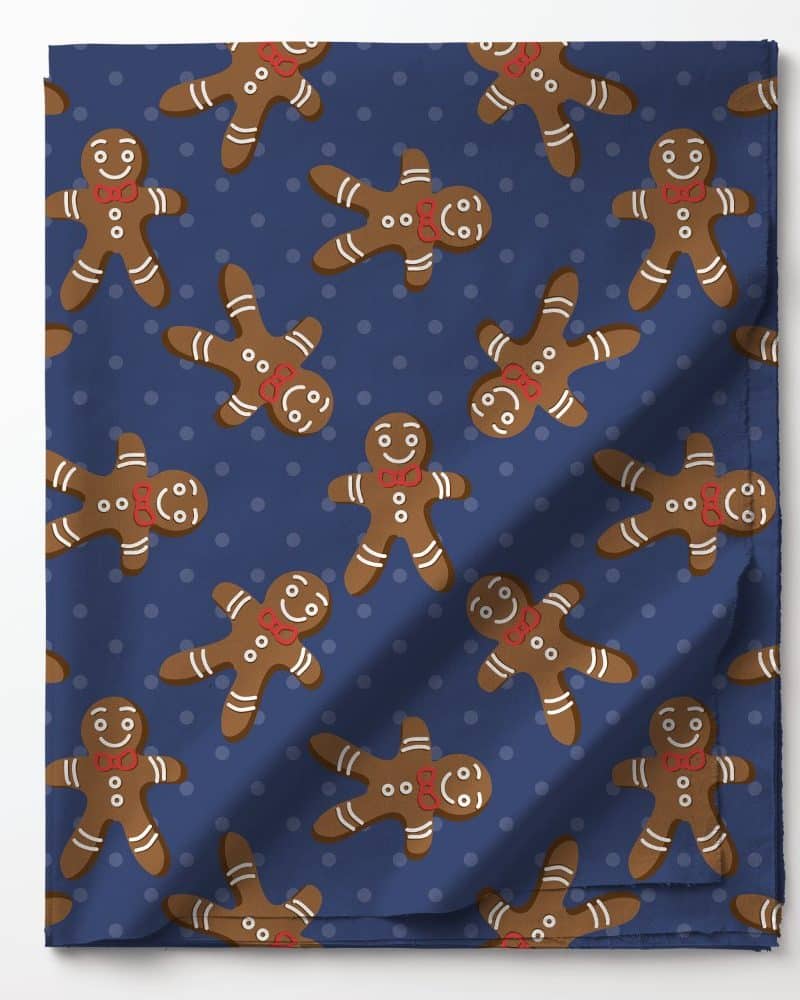 Blue fabric with a repeating pattern of gingerbread men wearing red bow ties.