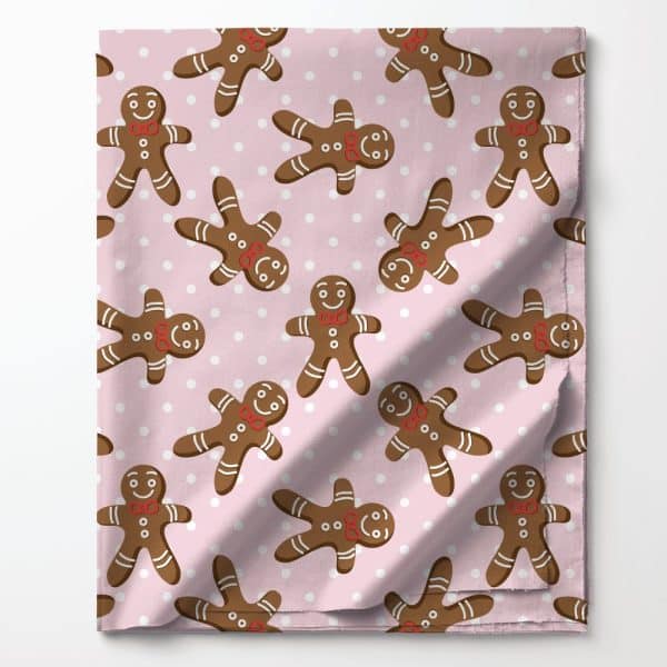 Pink Fabric With A Repeating Pattern Of Gingerbread Men Wearing Red Bow Ties.