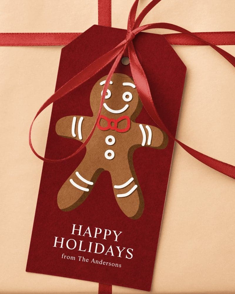 A red gift tag with a gingerbread man and the words Happy Holidays from The Andersons.