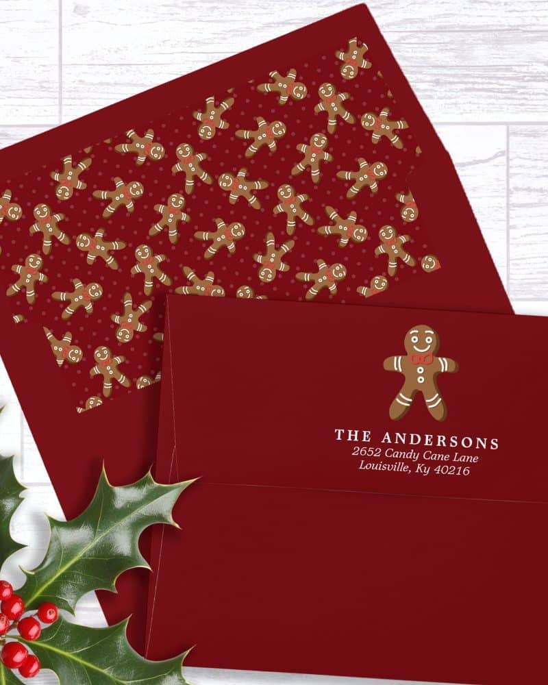 Red holiday envelope with a gingerbread man design and personalized address.