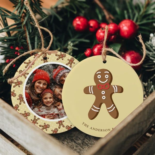 Two Round Christmas Ornaments; One Features A Family Photo Surrounded By Gingerbread Men, The Other Shows A Single Gingerbread Man With A Family Name.