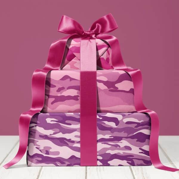 Stack Of Three Pink And Purple Camouflage-Patterned Gifts Tied With A Large Pink Ribbon.