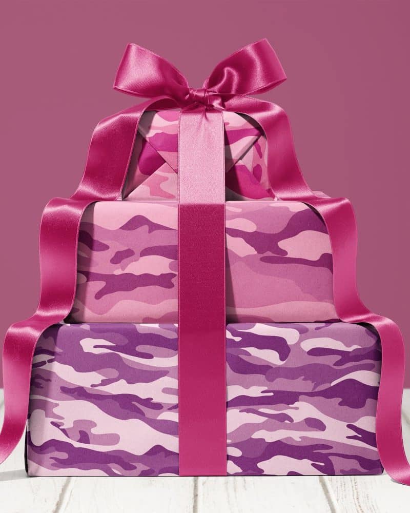 Stack of three pink and purple camouflage-patterned gifts tied with a large pink ribbon.