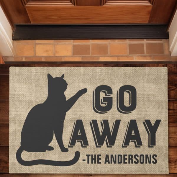 Beige Doormat With A Black Silhouette Of A Cat And The Words Go Away, Followed By The Andersons.