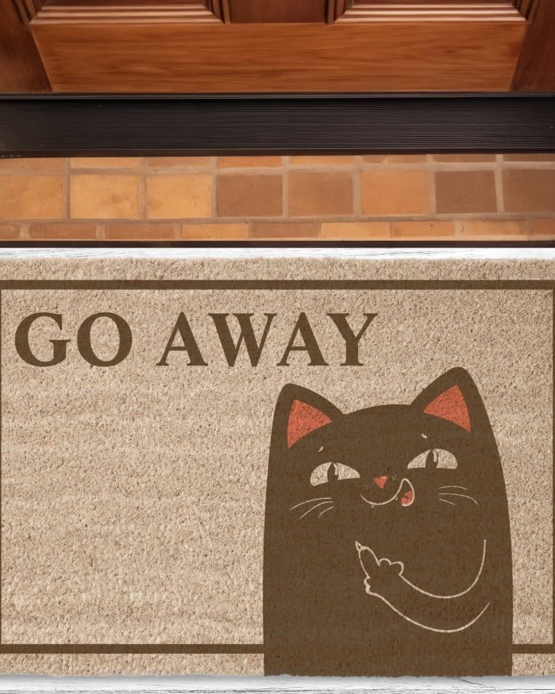 A tan doormat with the words Go Away and a cartoon cat giving a dismissive gesture.