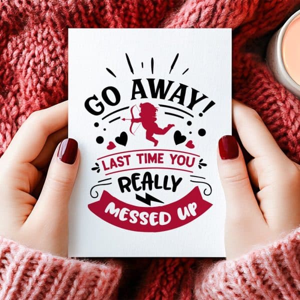 Two Hands Hold A Valentine'S Day Card With A Cupid Design And The Text Go Away! Last Time You Really Messed Up.