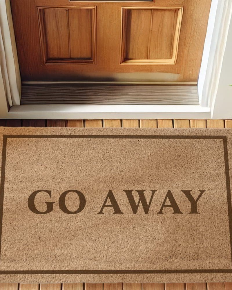 Tan doormat with the words Go Away in dark brown lettering.