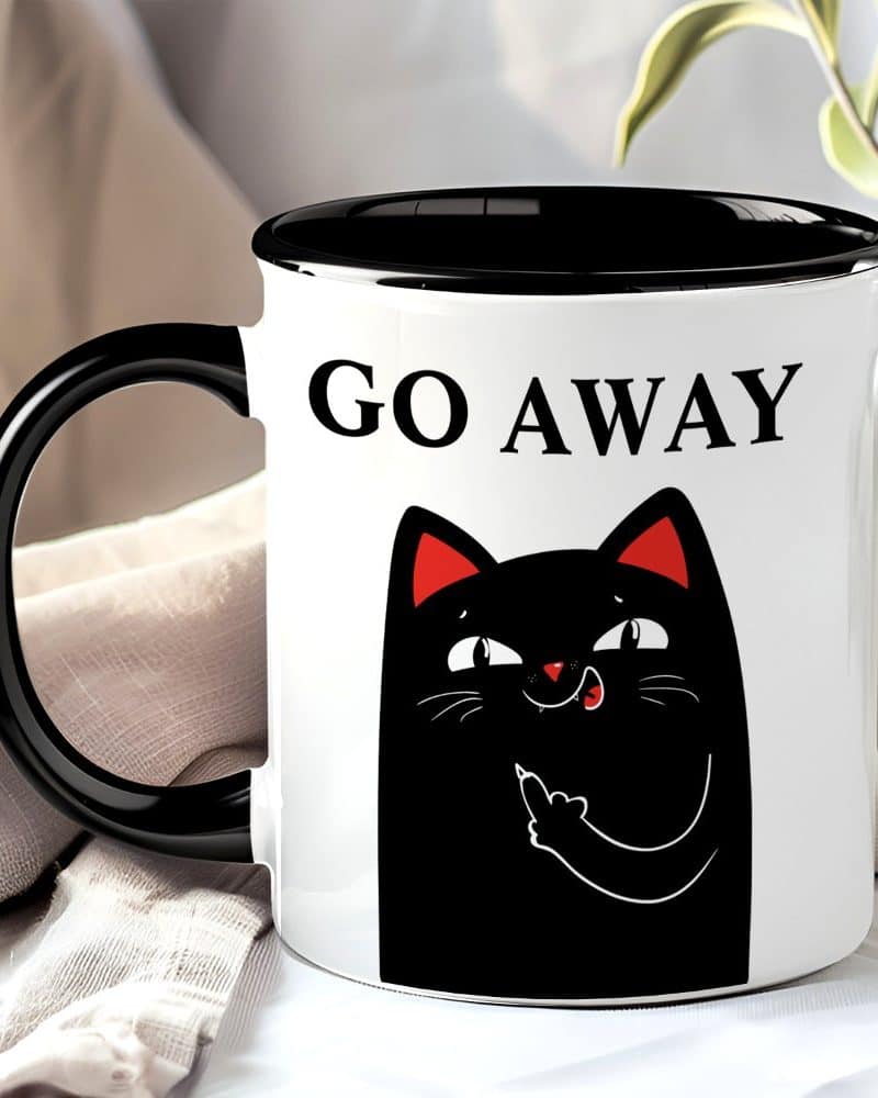 A white mug with a black handle and rim features a black cat giving the middle finger and the words Go Away.