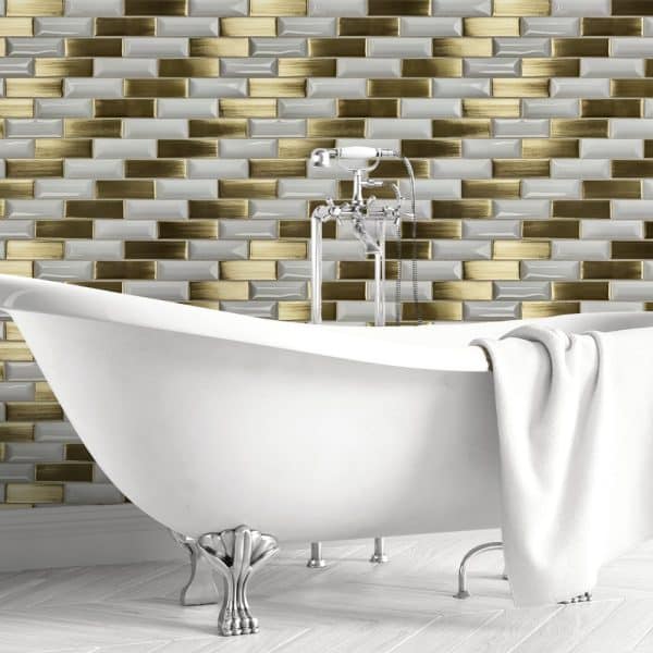 White Clawfoot Bathtub In Front Of Gold And White Brick Tile Wall.