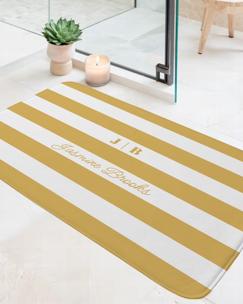 Mustard yellow and white striped bath mat with the initials JB and the name Jasmine Brooks.