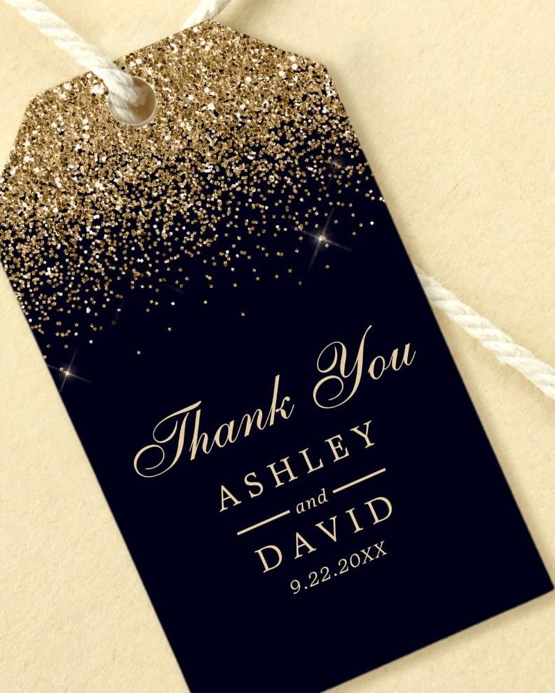Dark-blue thank you gift tag with gold glitter and the names Ashley and David.