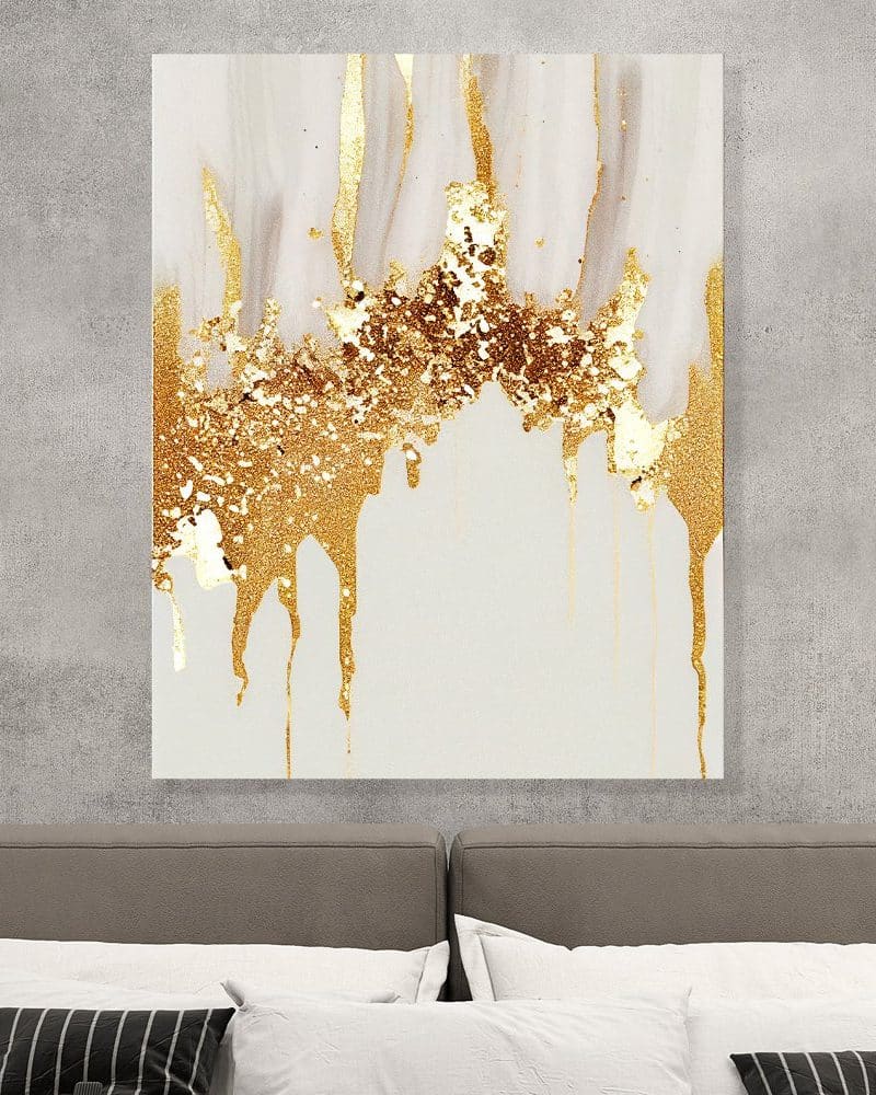 Abstract painting of gold dripping paint on a white background.