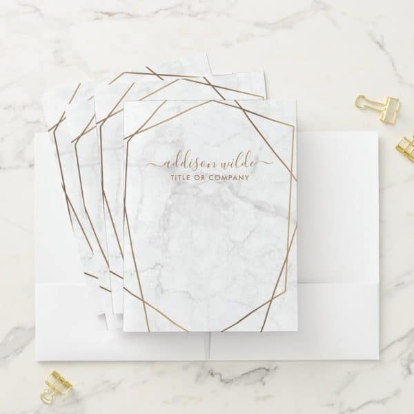 Stack Of Marble-Textured Stationery With Gold Geometric Border And Personalized Name.