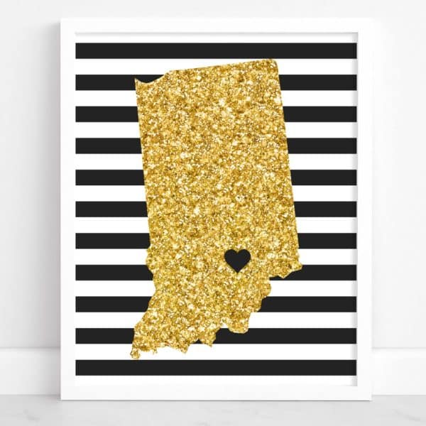 Gold Glitter Outline Of Indiana With A Small Black Heart In The Center, On Black And White Striped Background.