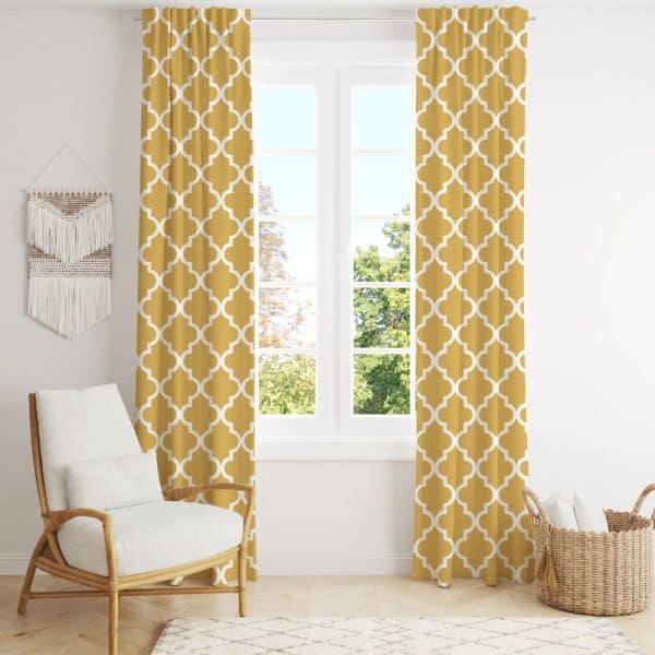 Mustard Yellow Curtains With A White Quatrefoil Pattern Hang In Front Of A Window.