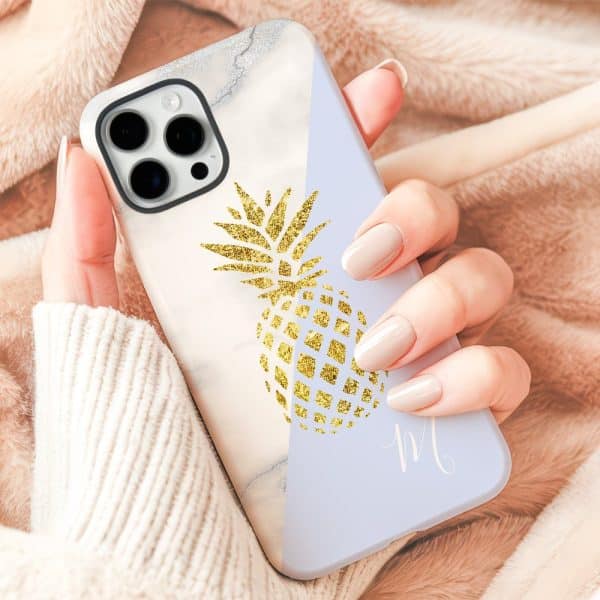 Hand Holding A Phone Case With A Gold Pineapple Design.