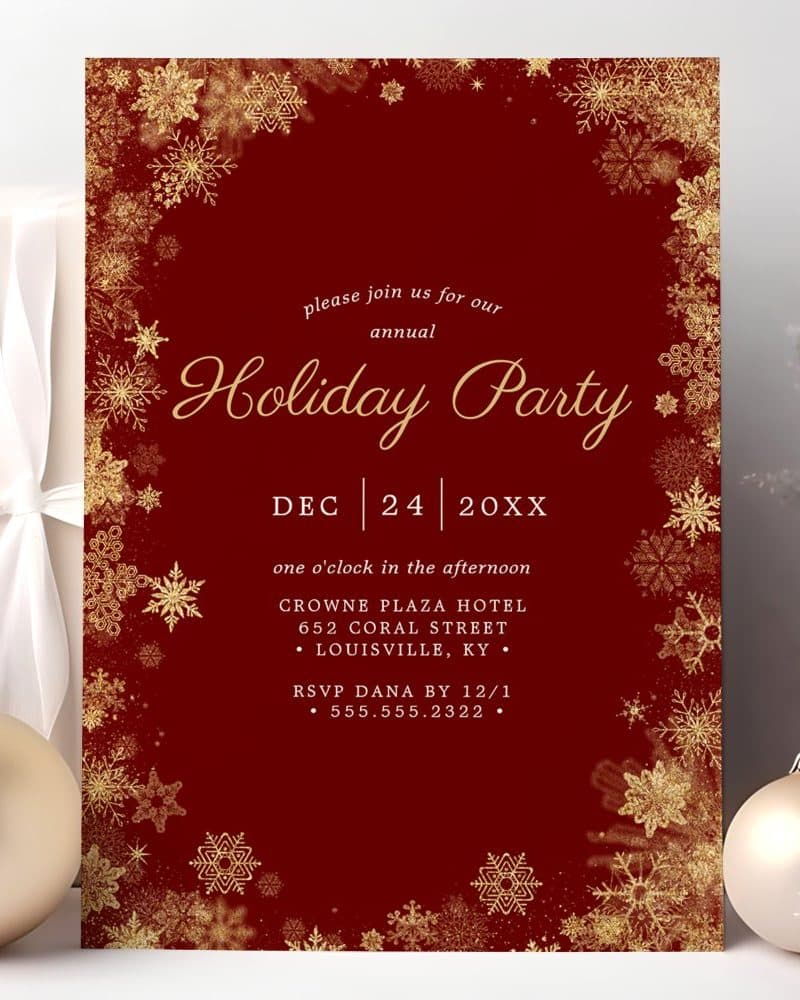 A dark red holiday party invitation with gold snowflakes.