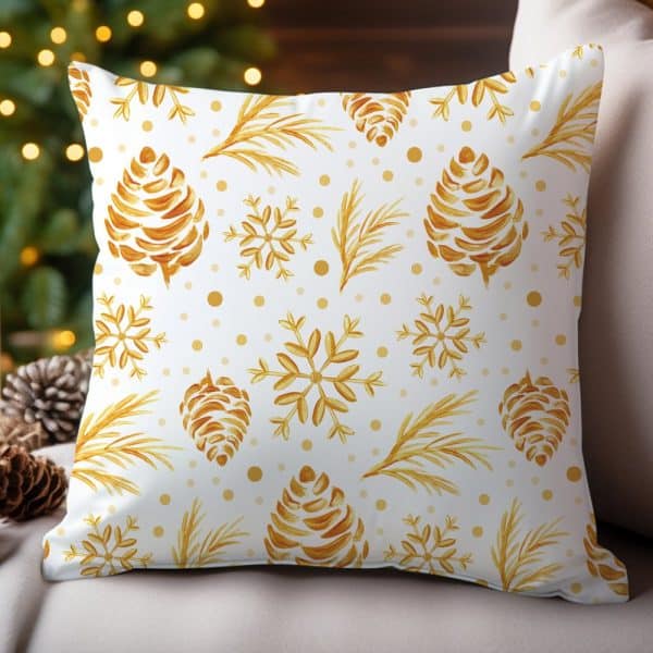 White Throw Pillow With A Gold Pine Cone And Snowflake Pattern.