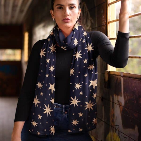 Woman Wearing A Navy Blue Scarf With A Gold Star Pattern.