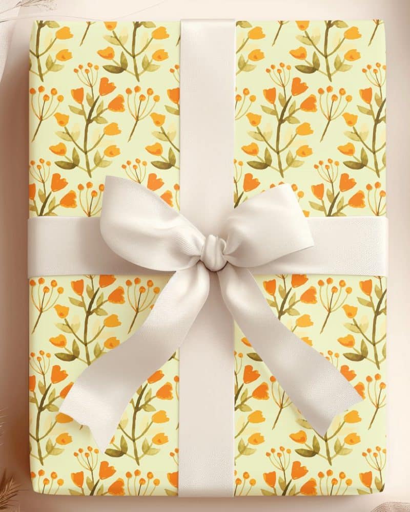 Gift box with pale yellow floral wrapping paper and a cream-colored ribbon.