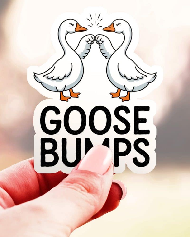 A hand holds up a sticker showing two geese fist-bumping, with the text Goosebumps below.