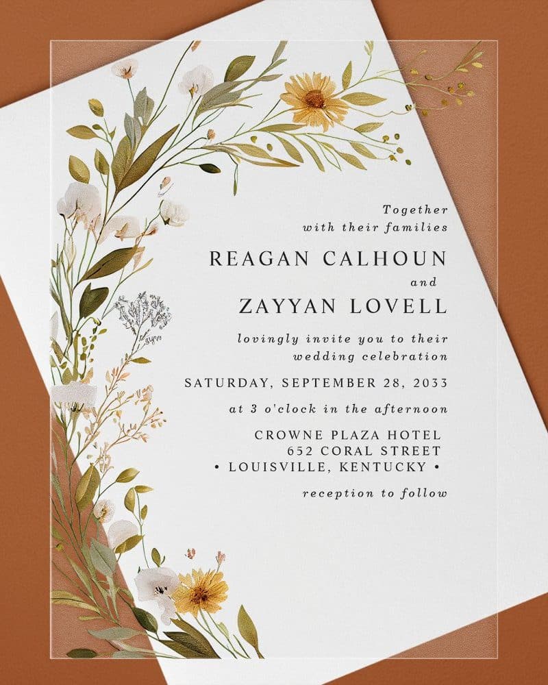 Wedding invitation for Reagan Calhoun and Zayyan Lovell, featuring a floral border.