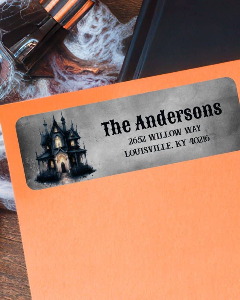 Halloween-themed return address label featuring a spooky house illustration and the address for The Andersons.