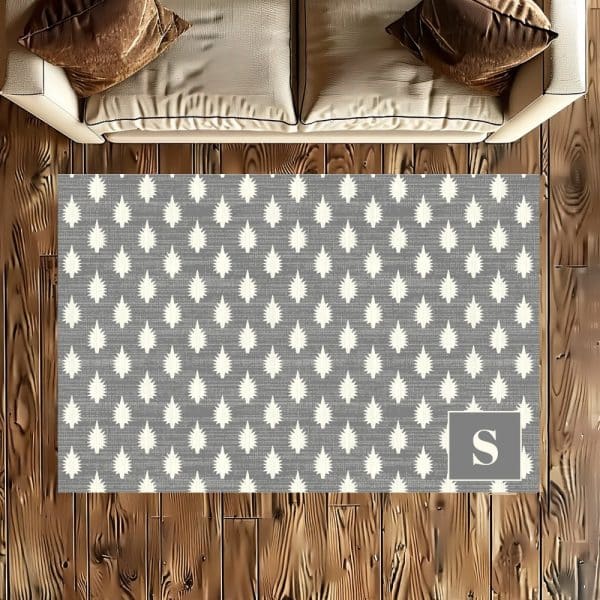 Gray Area Rug With A Repeating Pattern Of Small, Off-White Stylized Fir Trees And A Large, Off-White Letter S In The Lower Right Corner.