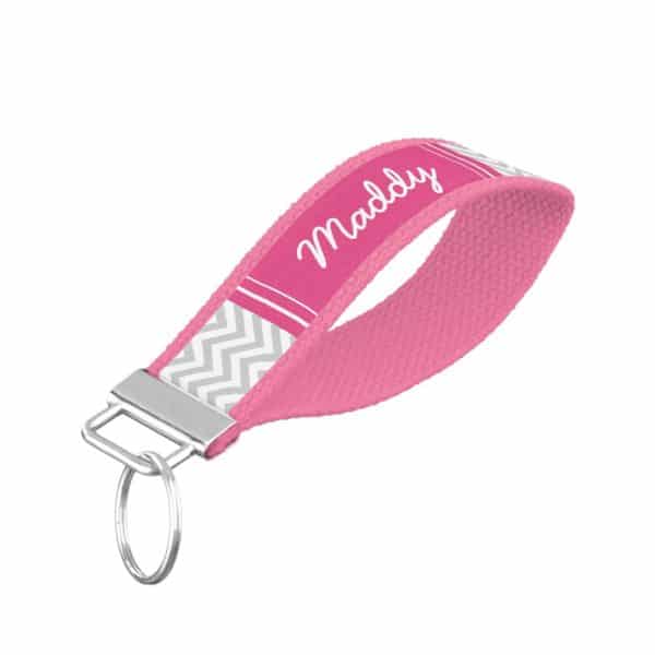 Pink Personalized Keychain With The Name Maddy And A Gray Chevron Pattern.