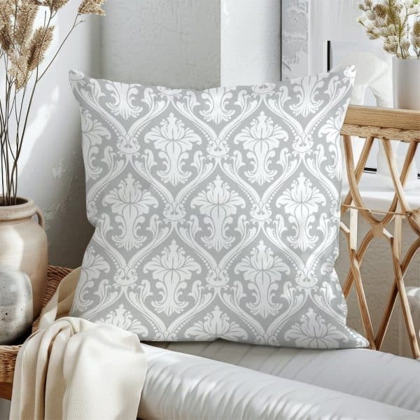 Grey Throw Pillow With A White Damask Pattern.
