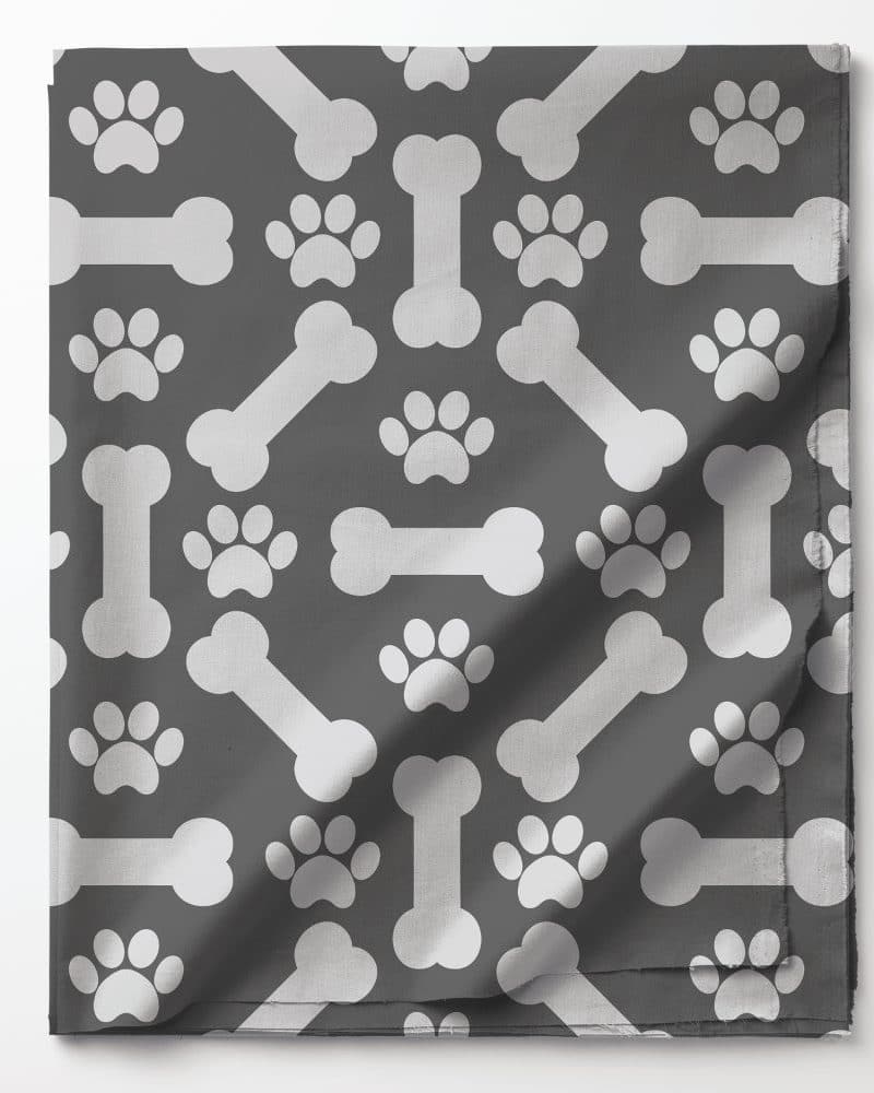 Gray fabric with a repeating pattern of white dog bones and paw prints.