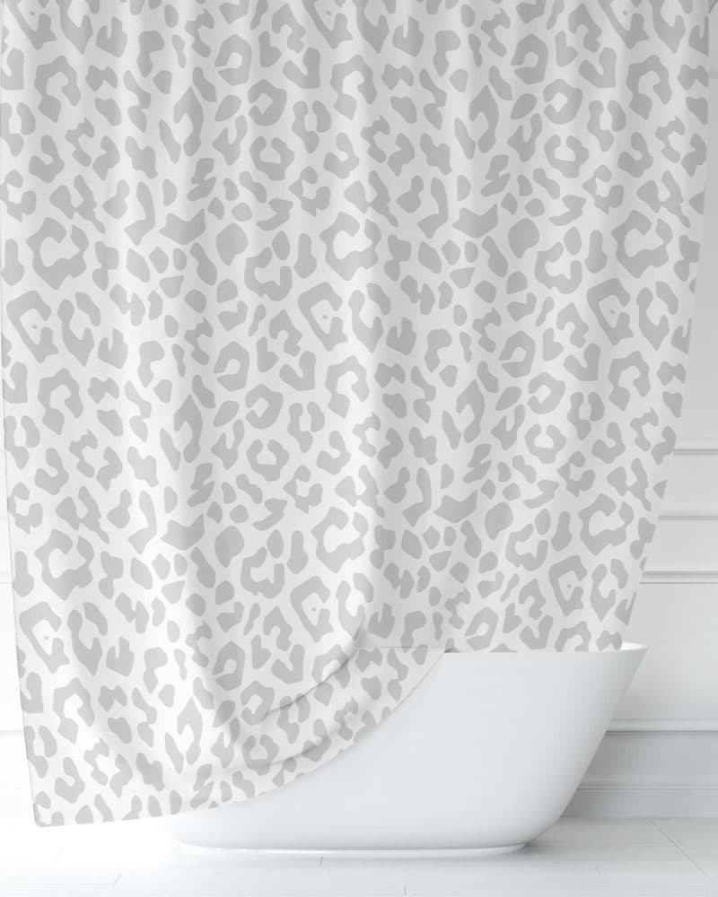 Grey and white shower curtain with a leopard print pattern.