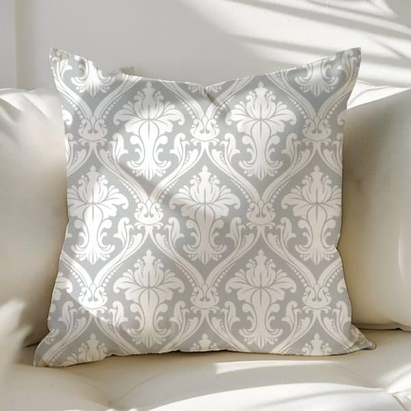 Gray Throw Pillow With A White Damask Pattern.